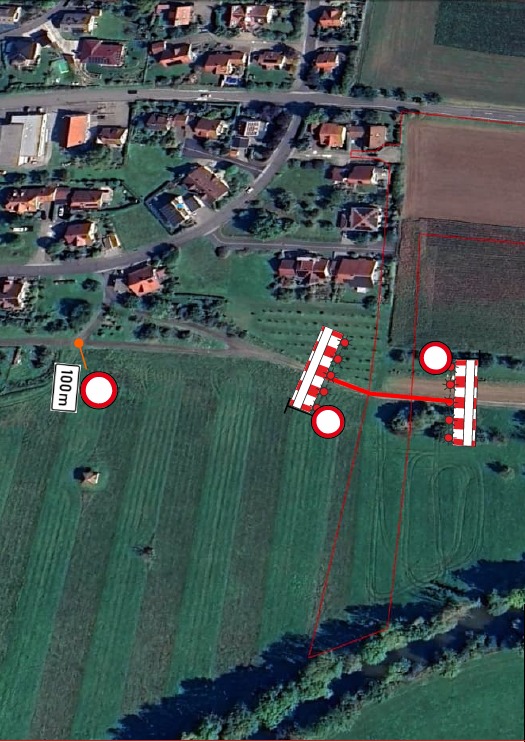 Dieser Alternativtext wurde KI-generiert: Ein Luftbild zeigt eine Wohngegend mit Häusern und Feldern. Im Vordergrund sind Markierungen und Linien auf einer Wiese zu sehen.