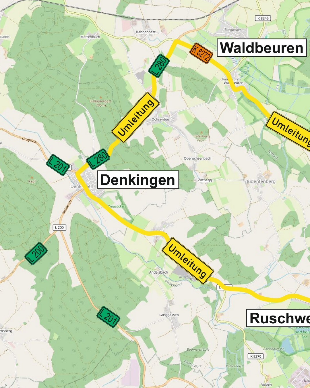 Eine detaillierte topografische Karte zeigt Straßen, Felder und Hügel mit Ortsnamen. Mehrere Hinweisschilder weisen auf Umleitungen hin.