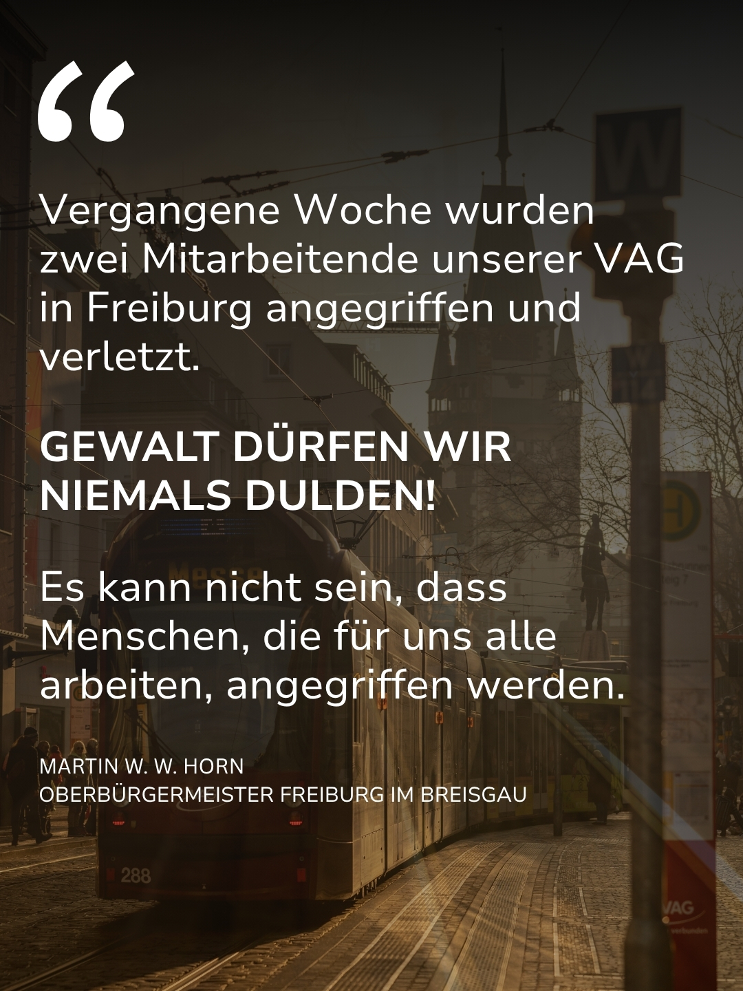 Zitat von Martin W. W. Horn, Oberbürgermeister Freiburg im Breisgau, vor dem Hintergrund einer roten Straßenbahn: „Vergangene Woche wurden zwei Mitarbeitende unserer VAG in Freiburg angegriffen und verletzt. GEWALT DÜRFEN WIR NIEMALS DULDEN! Es kann nicht sein, dass Menschen, die für uns alle arbeiten, angegriffen werden.“ (KI-Alternativtext)