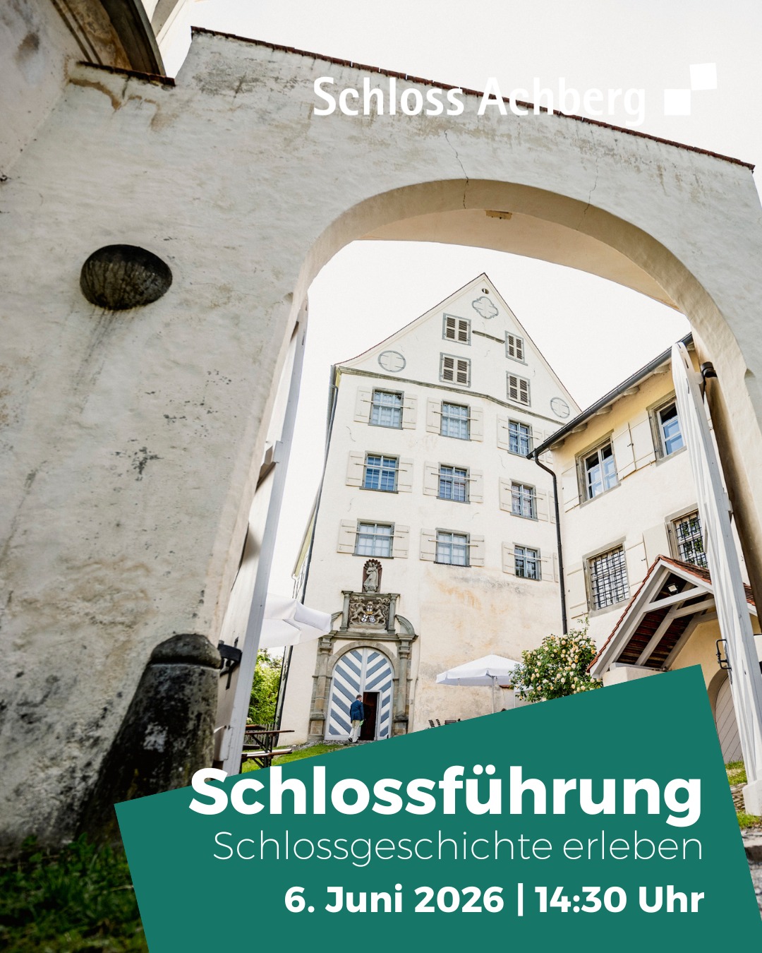 Schloss Achberg: Blick durch einen Torbogen auf das Schlossgebäude mit Eingangstür und Fenstern. Im Vordergrund grüner Banner mit Text „Schlossführung, Schlossgeschichte erleben, 6. Juni 2026 | 14:30 Uhr“. (KI-Alternativtext)