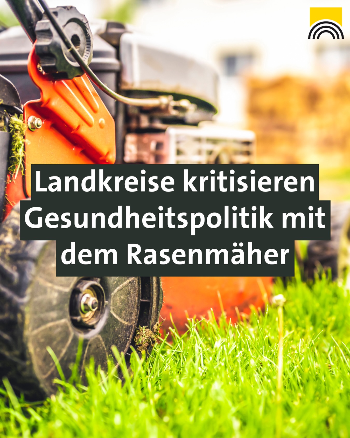 Dieser Alternativtext wurde KI-generiert: Ein Rasenmäher steht auf einem grünen Rasen vor einem unscharfen Hintergrund. Vor dem Rasenmäher befindet sich ein Textfeld mit Schrift.