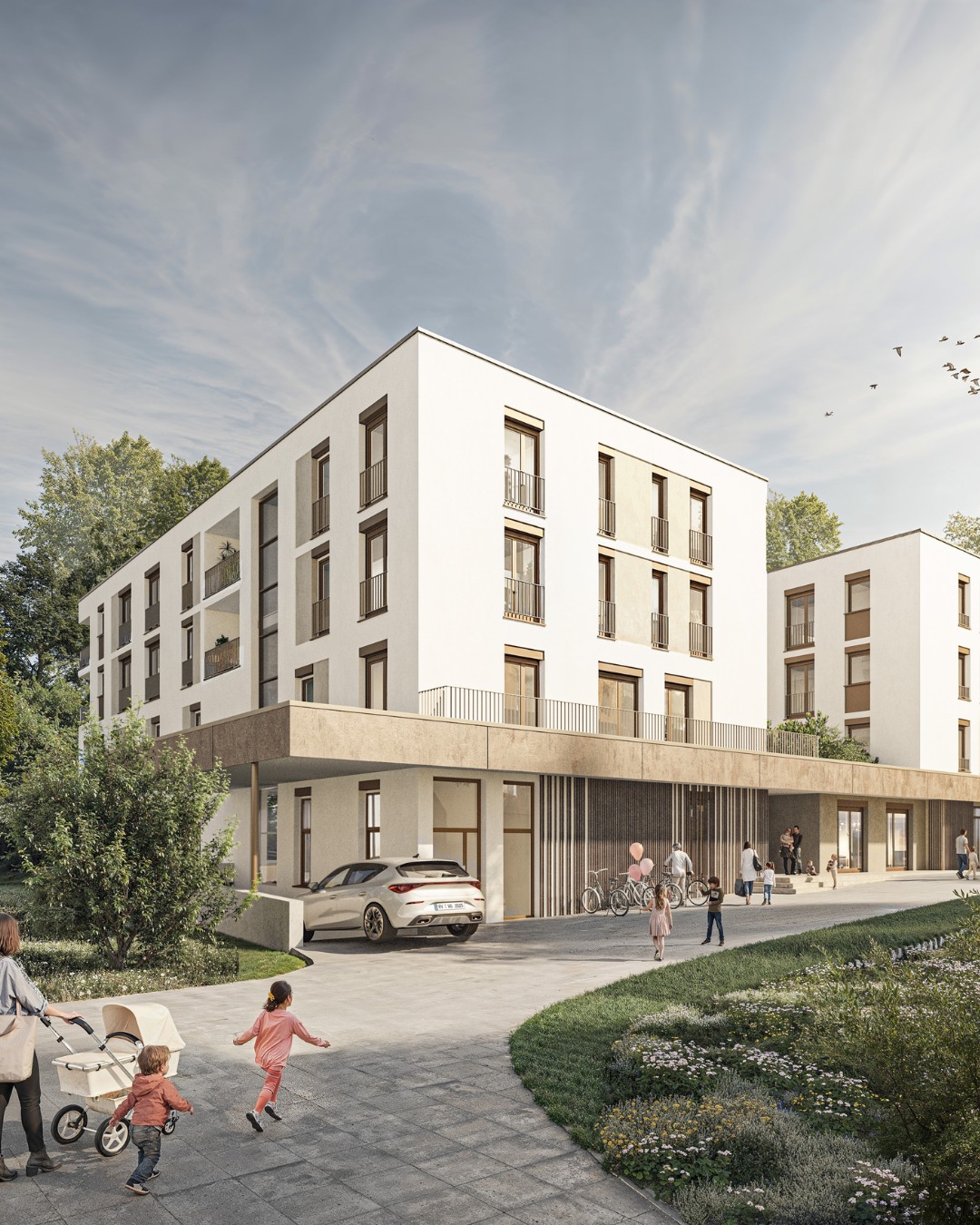 Dieser Alternativtext wurde KI-generiert: Ein modernes, mehrstöckiges Gebäude mit weißen Fassaden und großen Fenstern. Vor dem Gebäude befindet sich ein gepflegtes Gelände mit Autos, Pflanzen und Personen.