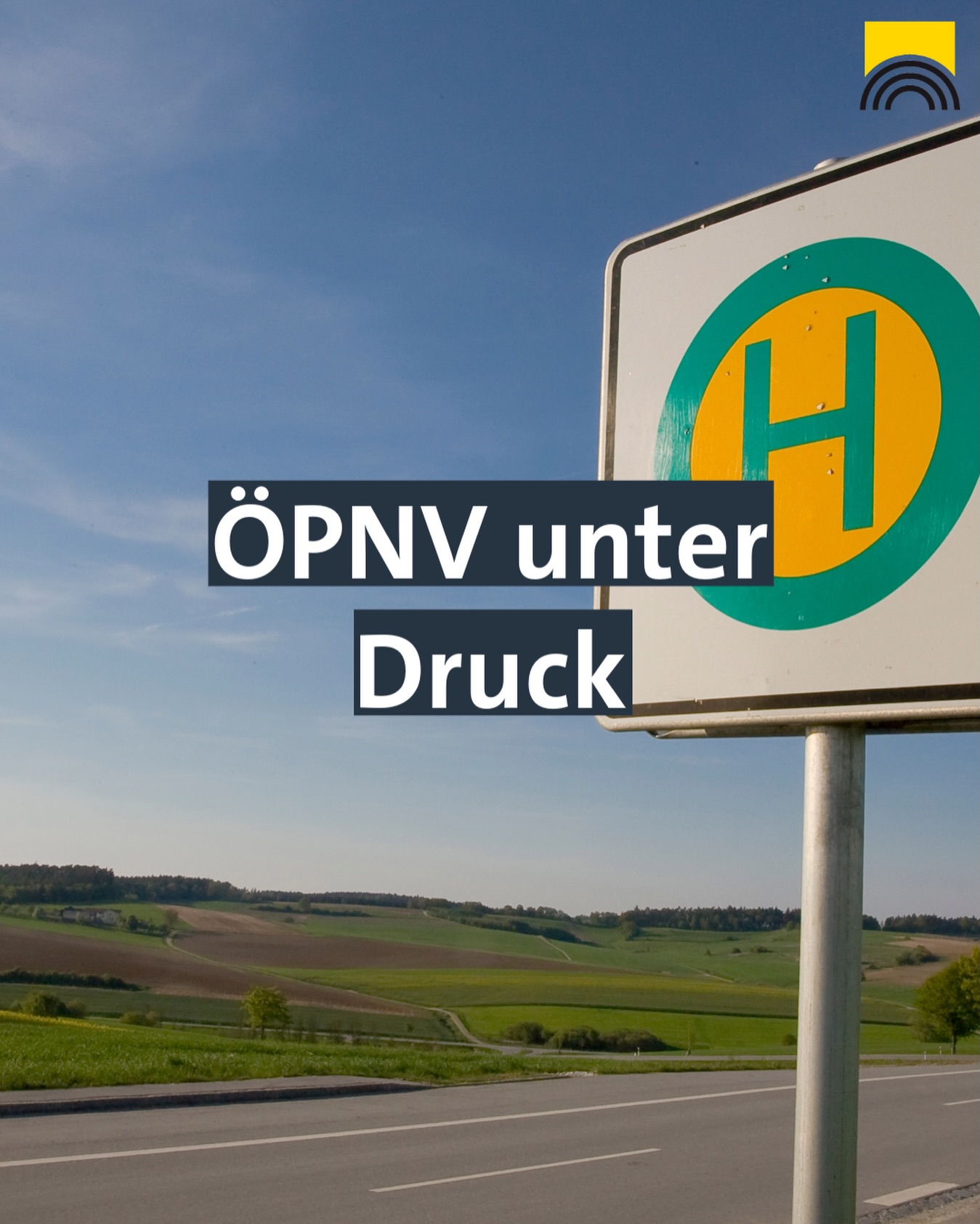 Dieser Alternativtext wurde KI-generiert: Ein Verkehrsschild mit dem Aufdruck 'ÖPNV unter Druck' ist vor einer ländlichen Landschaft zu sehen. Die Farben sind lebendig, und der Himmel ist blau.