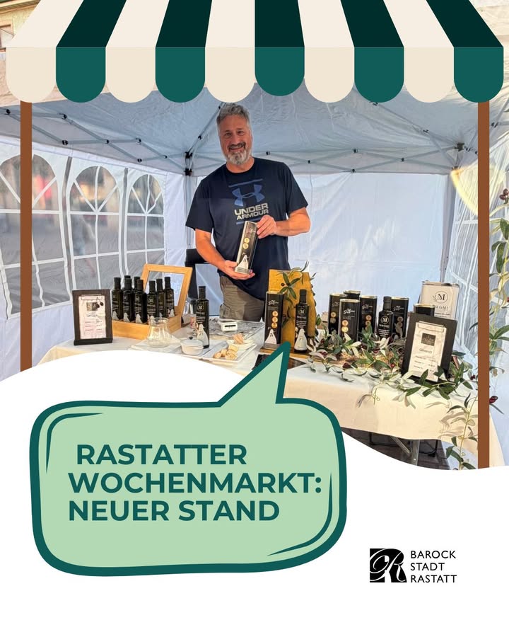 Person mit grauem Haar und Bart steht unter einem Zelt mit grün-weißem Vordach und präsentiert eine Produktverpackung. Der Tisch davor ist mit zahlreichen Flaschen, Schachteln und Olivenzweigen bestückt. Ein grüner Textbaustein unten links lautet „RASTATTER WOCHENMARKT: NEUER STAND“, rechts unten ist das Logo der Barockstadt Rastatt zu sehen. (KI-Alternativtext)