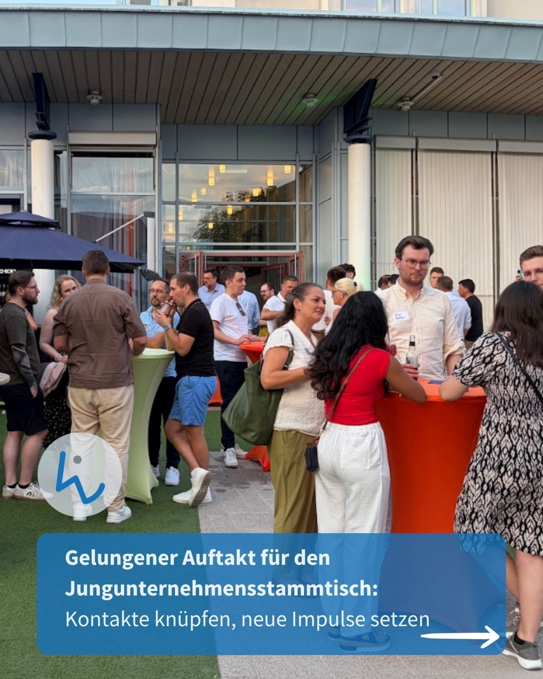 Menschen stehen im Freien vor einem Gebäude und unterhalten sich bei einem Networking-Treffen mit hohen Tischen. Ein blauer Textbanner unten lautet: „Gelungener Auftakt für den Jungunternehmensstammtisch: Kontakte knüpfen, neue Impulse setzen“. (KI-Alternativtext)