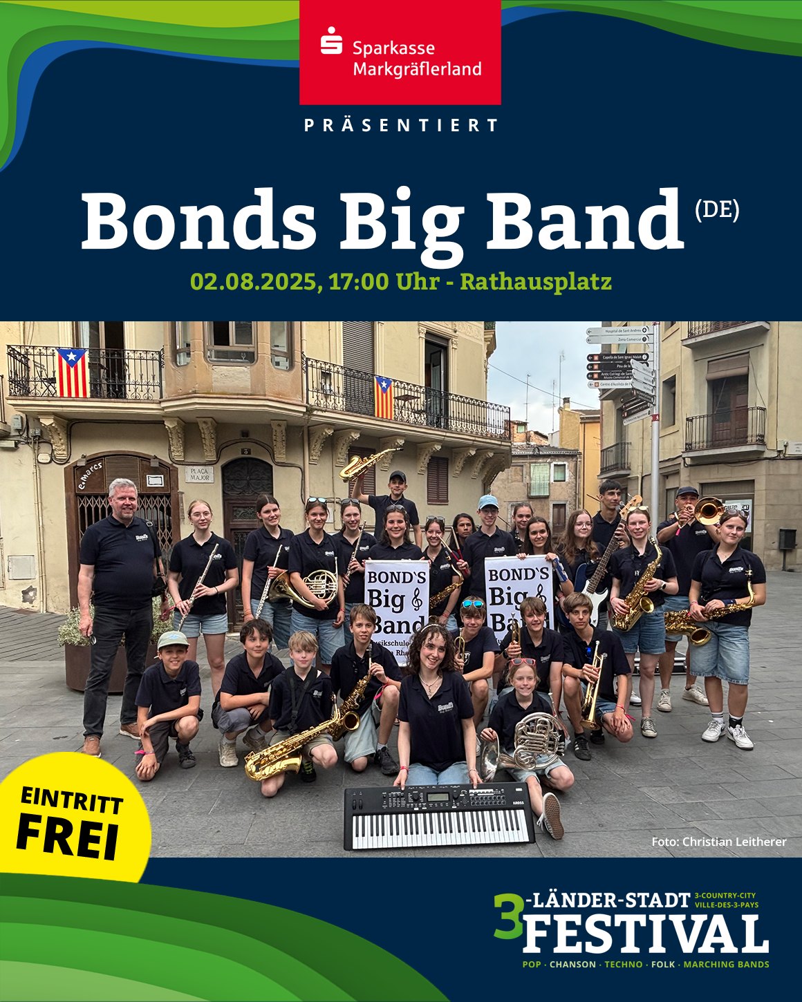 Eine Gruppe von Menschen hält Musikinstrumente und posiert auf einem Platz vor Gebäuden. Das Bild ist eine Ankündigung für eine Veranstaltung.